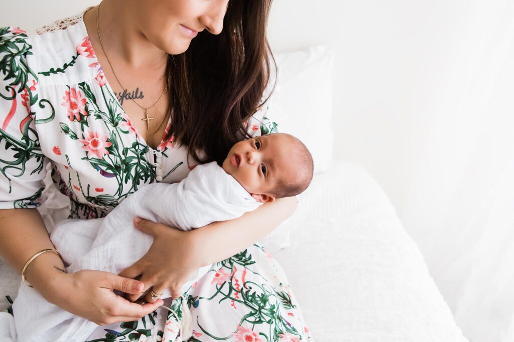 Newborn baby being cradled in his mother's arms. 