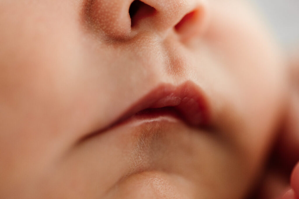 Close up macro image of newborn babies lips taken during newborn photoshoot.