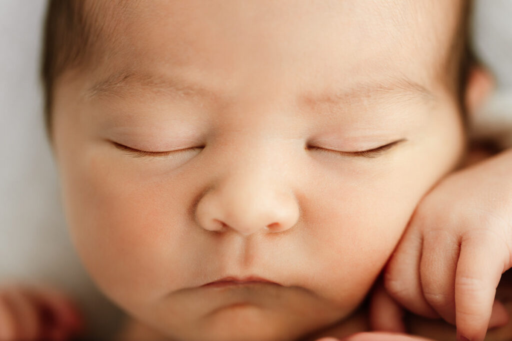 Close up macro image of newborn babies face and eyelashes taken during newborn photoshoot.