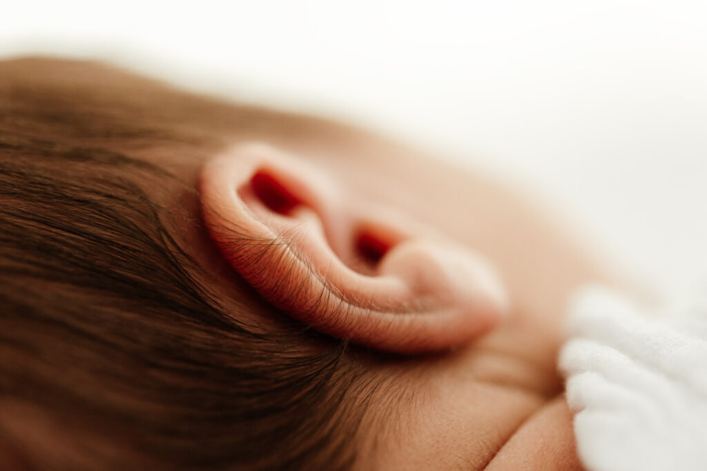 Close up macro image of newborn babies ear taken during newborn photoshoot.