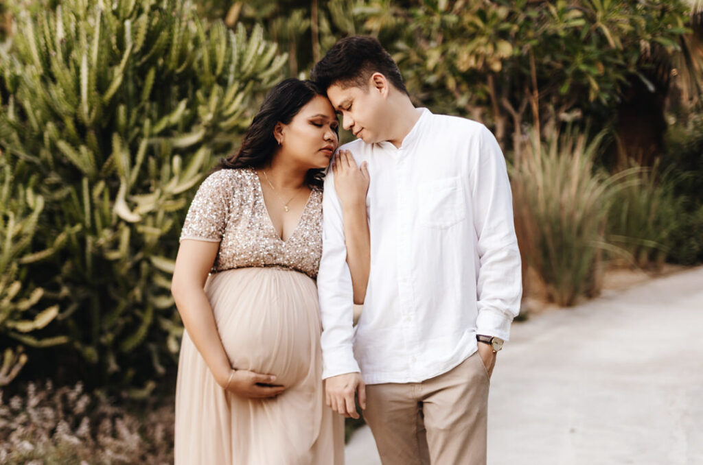 Expecting parents walking through  Umm Al Emarat Park in Abu Dhabi during a maternity photo shoot. 