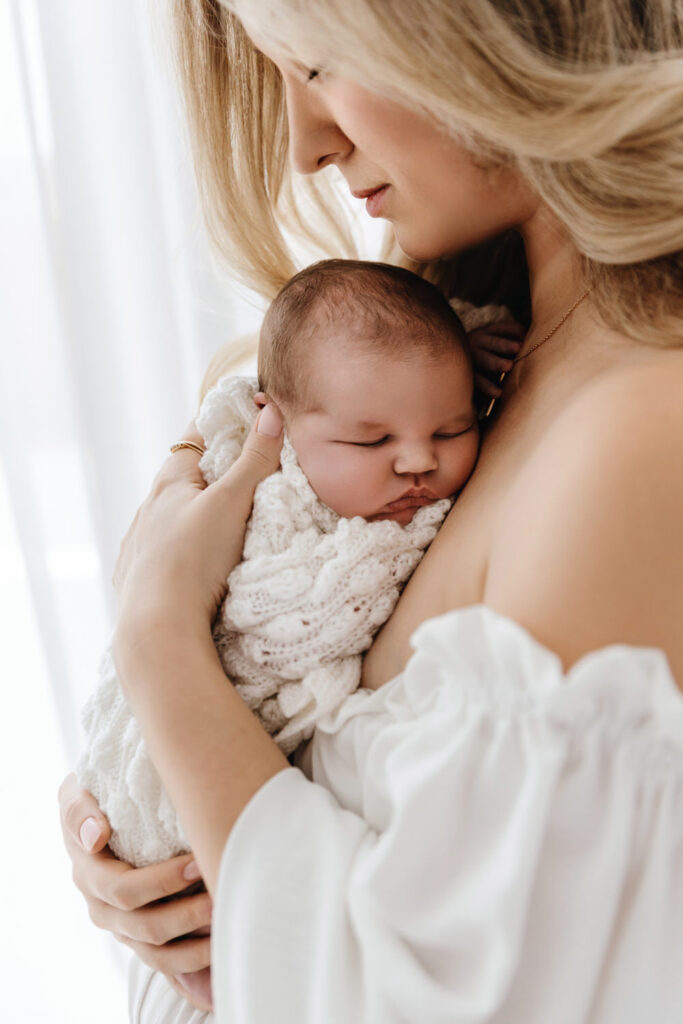 The mother is holding the baby in her arms in Abu Dhabi